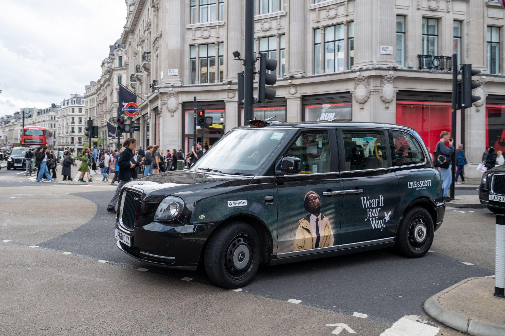 A Lyle & Scott Wear It Your Way superside on a black cab at Oxford Circus