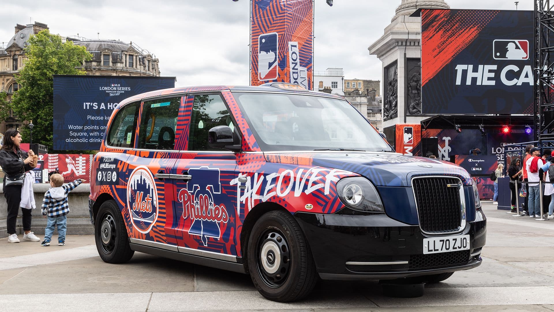 A Major League Baseball London Series wrapped electric black cab at the Trafalgar Square fan event